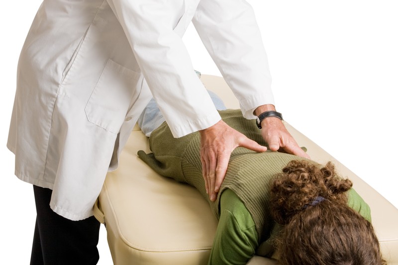 chiropractor doing a back adjustment