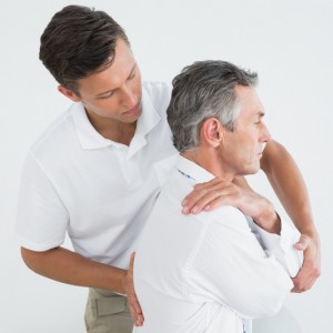 chiropractor adjusting a patient's back