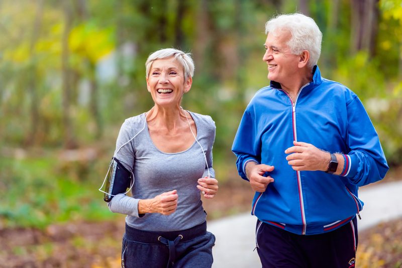 Smiling senior couple enjoying a jog outside together