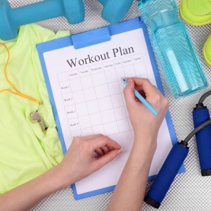 Sports trainer amounts to workout plan close-up