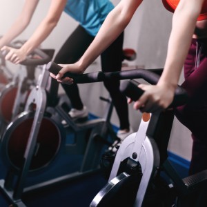 people working out on indoor bicycles