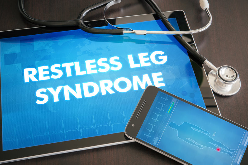 iPad and digital devices portraying "Restless Leg Syndrome" on their screens.