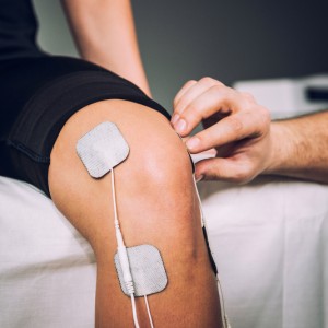 Patient receiving electrostimulation therapy for his knee pain