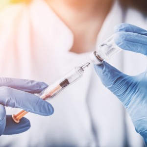 medical professional drawing an injection for a patient