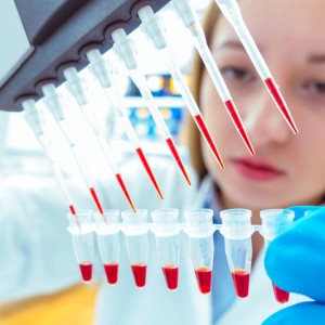 Woman testing liquid in a lab