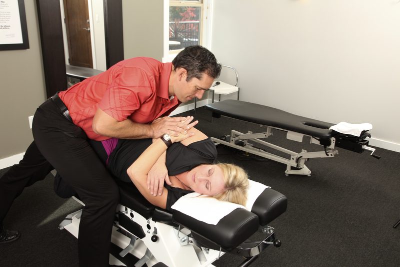 Chiropractor adjusting female patient