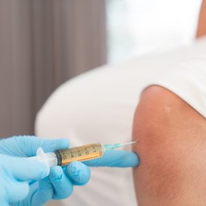 Patient receiving an injection into the knee