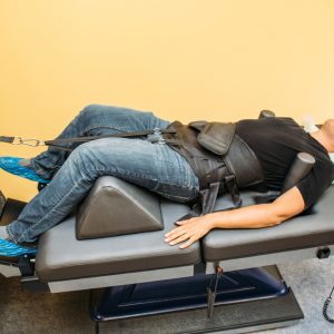 Man laying down on special spinal decompression table receiving treatment